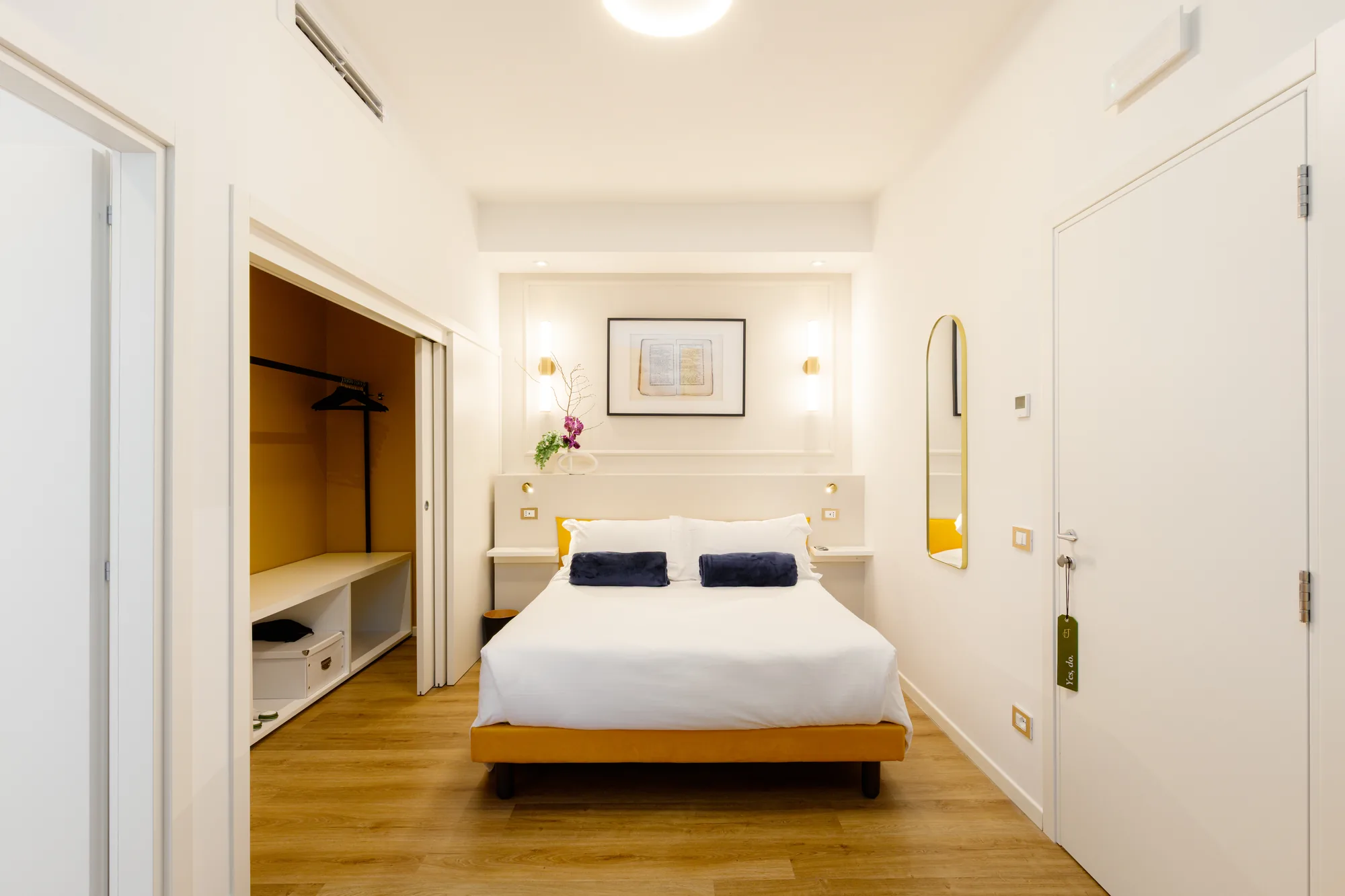 Modern bedroom with double bed, built-in wardrobe, and minimalist decorations
